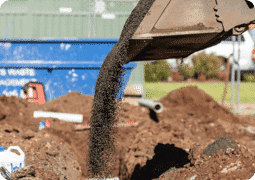 Excavator Unloading A Soil — Central West Plumbing & Civil Drainage In Dubbo, NSW