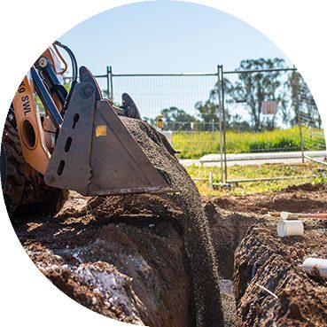 Bulldozer Filling Trench With Dirt — Central West Plumbing & Civil Drainage In Dubbo, NSW
